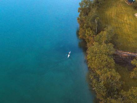 Bird's eye view of a kayaker on the crystal clear waters on Clearwater Lake