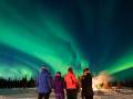 Four People Under The Northern Lights