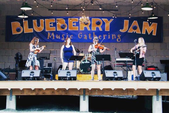 Four musicians on stage at the Blueberry Jam Music Festival.