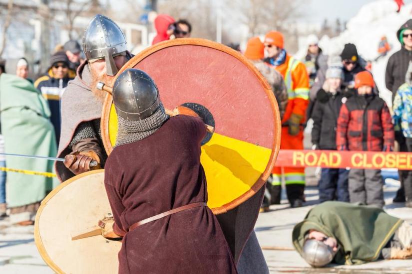 Thrilling Gimli Viking combat unfolds as intrigued pedestrians gather to witness the historical reenactment.
