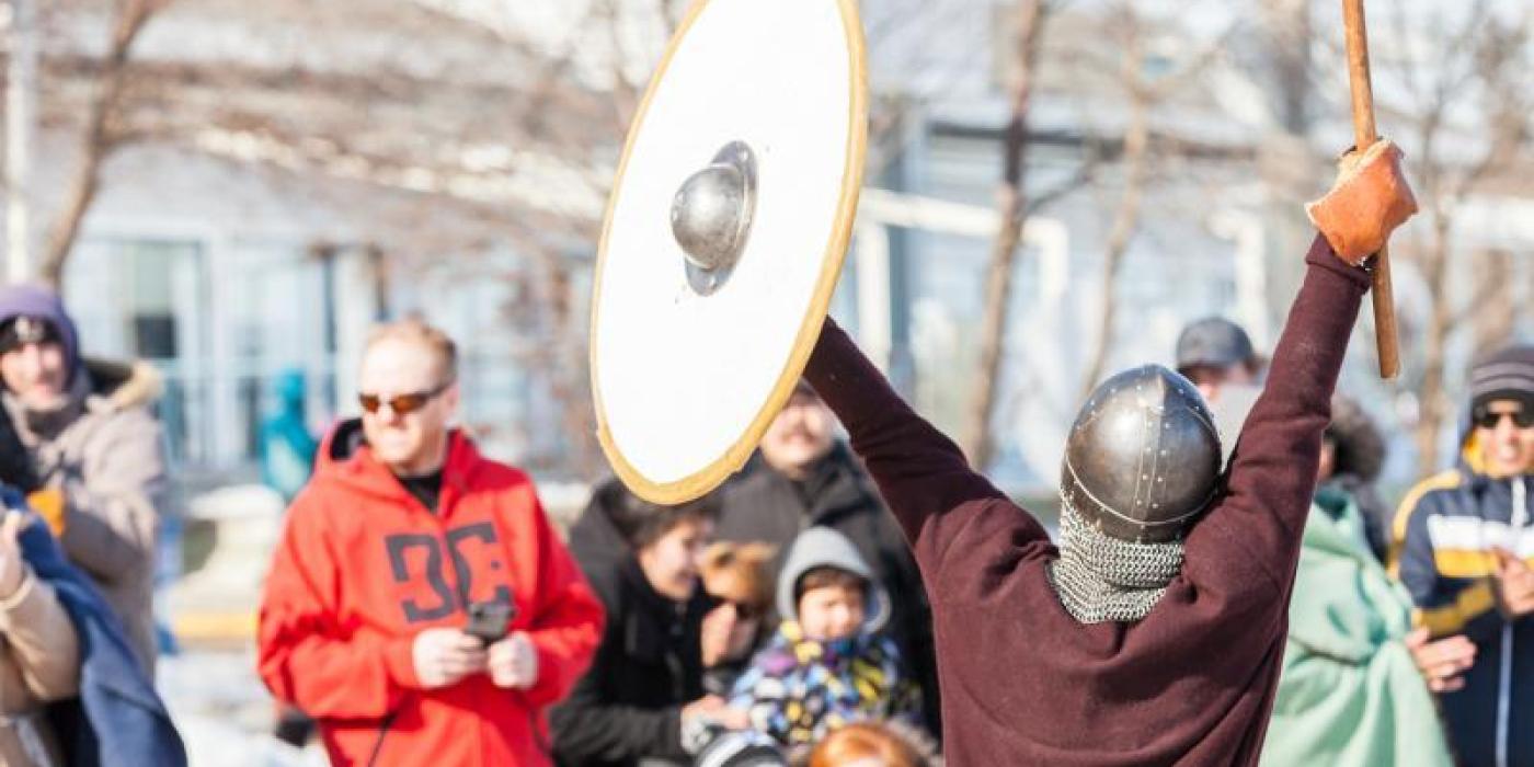 Thrilling Gimli Viking combat unfolds as intrigued pedestrians gather to witness the historical reenactment.