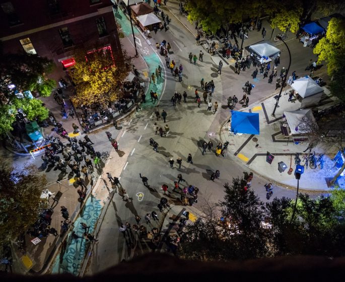 Crowds of people seen from above on the streets of Winnipeg's Exchange District for Nuit Blanche.