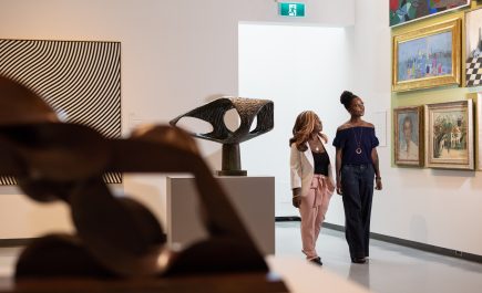 Dos mujeres disfrutan de una exposición en la Galería de Arte de Winnipeg.