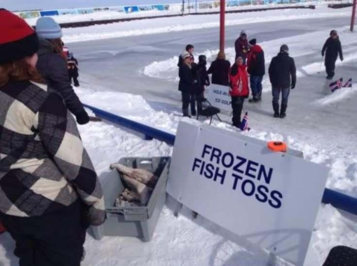 Gimli fish tossJoyful participants engage in Gimli's frozen fish toss, celebrating winter fun and community spirit.