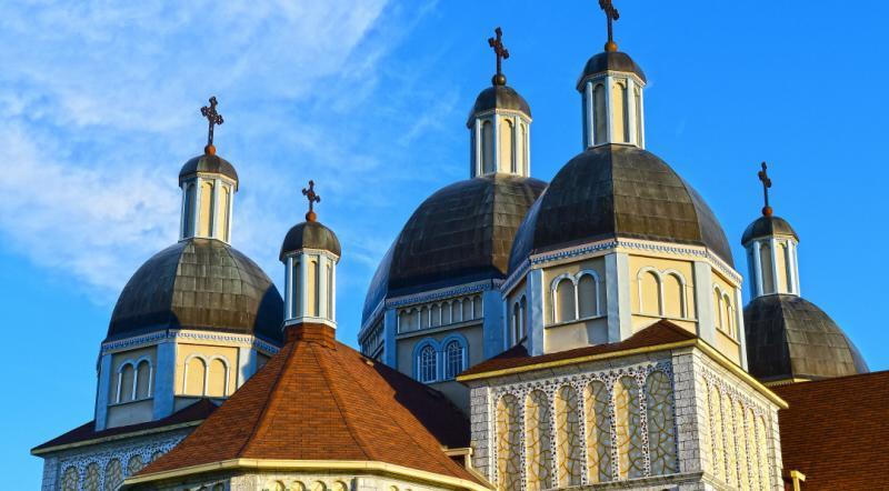 Rooftops of Immaculate Conception Church Of Cooks Creek, showcasing intricate architecture against the sky.