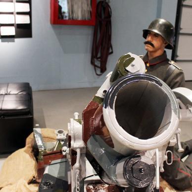 Resolute male soldier bundled up, steadfastly carrying a cannon, reflecting strength and determination.