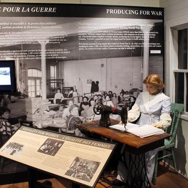 Depiction of a dedicated woman sewing at a desk, exemplifying the essential role of production for wartime efforts.