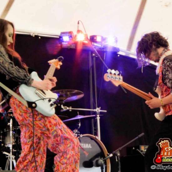 Fire and Water guitar duo on stage: A dynamic performance blending passion and harmony in a mesmerizing musical experience.