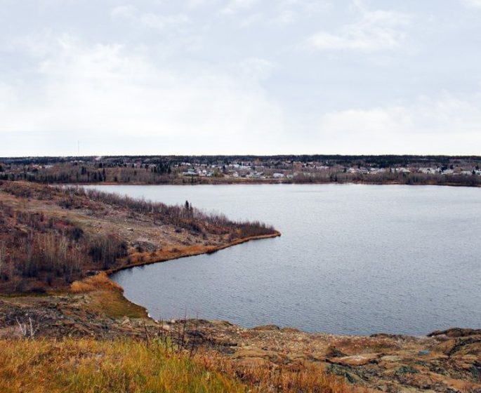 Flin Flon: Fall open water bay with city community across.