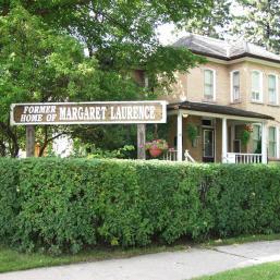 Margaret Laurence Home sign and exterior, featuring a historic building with a welcoming facade and informative signage.