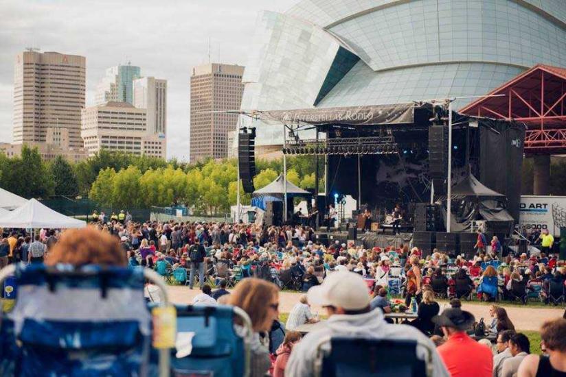 Interstellar Rodeo community setup: Vibrant gathering in front of Canada Inn stage, celebrating music and culture.