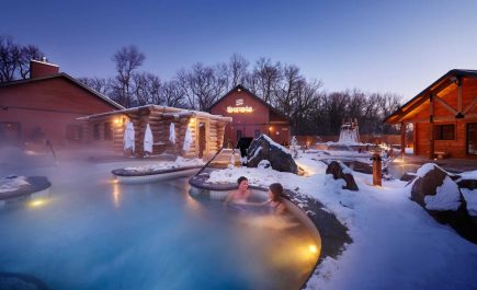 A few people enjoying the hot pools in the early winter evening at Thermea.