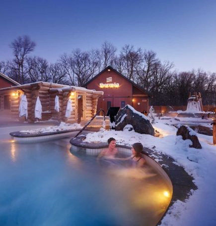 A few people enjoying the hot pools in the early winter evening at Thermea.