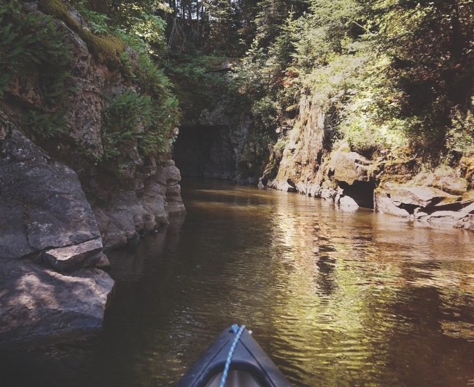 Canoeing through the Caddy Lake Tunnels.