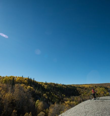 Mountainbiker halten auf dem Gipfel des Bald Hill an, um die Aussicht im Riding Mountain National Park zu genießen.
