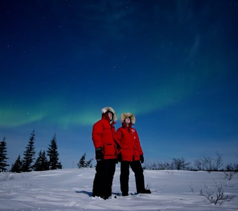 Two people watching the northern lights in Churchill