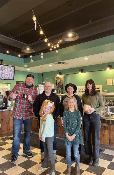 The family posing with the crew at Chez Angela.