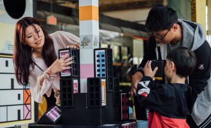 A mother and her children elxpore at the Children's Museum.