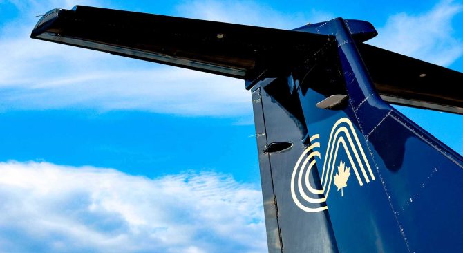 Close up on the Calm Air logo on the tail of an airplane.