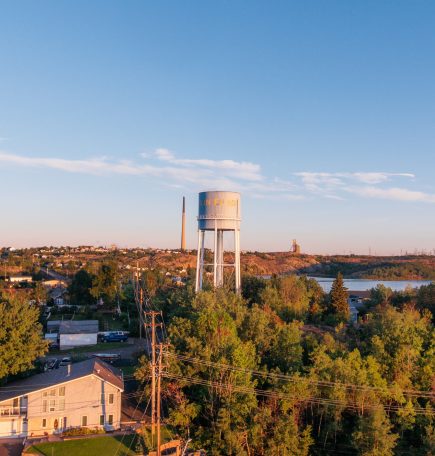 Drone photo overlooking the northern town of Flin Flon with a water tower in the distance.