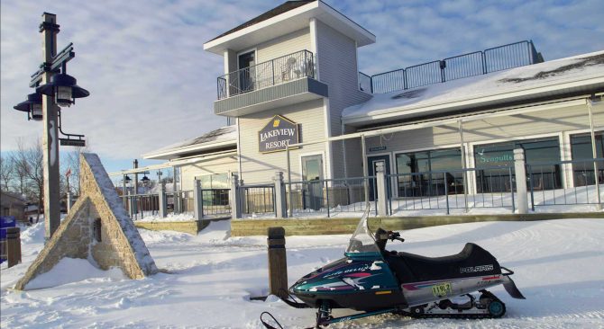 A snowmobile sits in front of the Lakeview Resort in Gimli, waiting to head out on the ice.