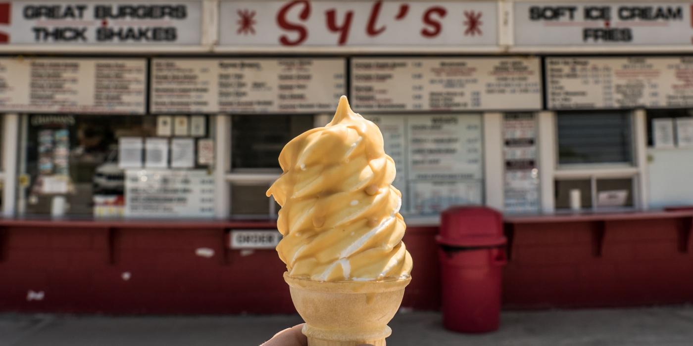 Holding an ice cream cone in front of Syl's Drive In