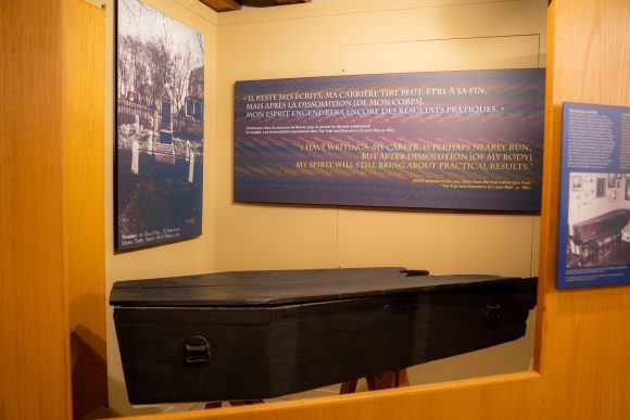 A small black coffin belong to Louis Riel sits in an exhibit at St. Boniface Museum