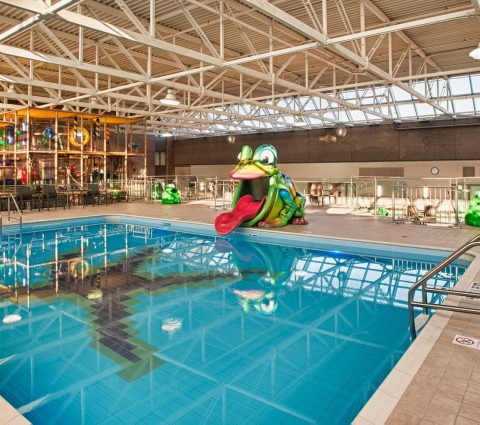 The main pool with fun animal shaped slides and a kids playground at Holiday Inn Winnipeg Airport West.