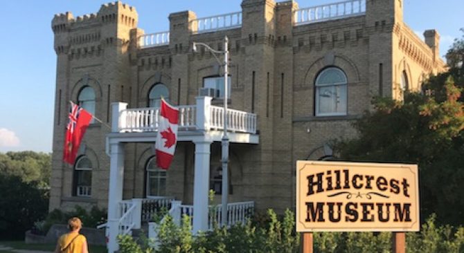 A person walking up the front path to the Hillcrest Museum in Souris.