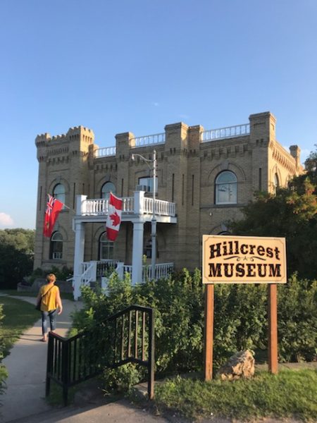 A person walking up the front path to the Hillcrest Museum in Souris.
