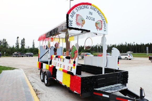 A red, black, white and yellow parade float for the Opaskwayak Indian Days parade.