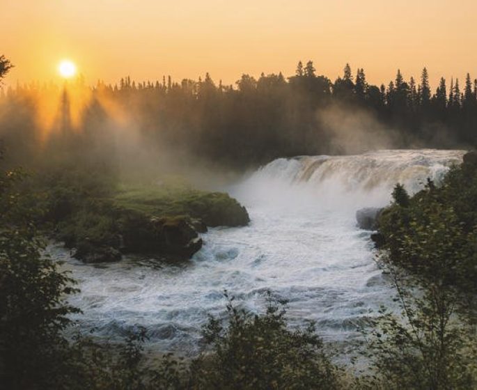 Sunset through the rising mist at Pisew Falls.